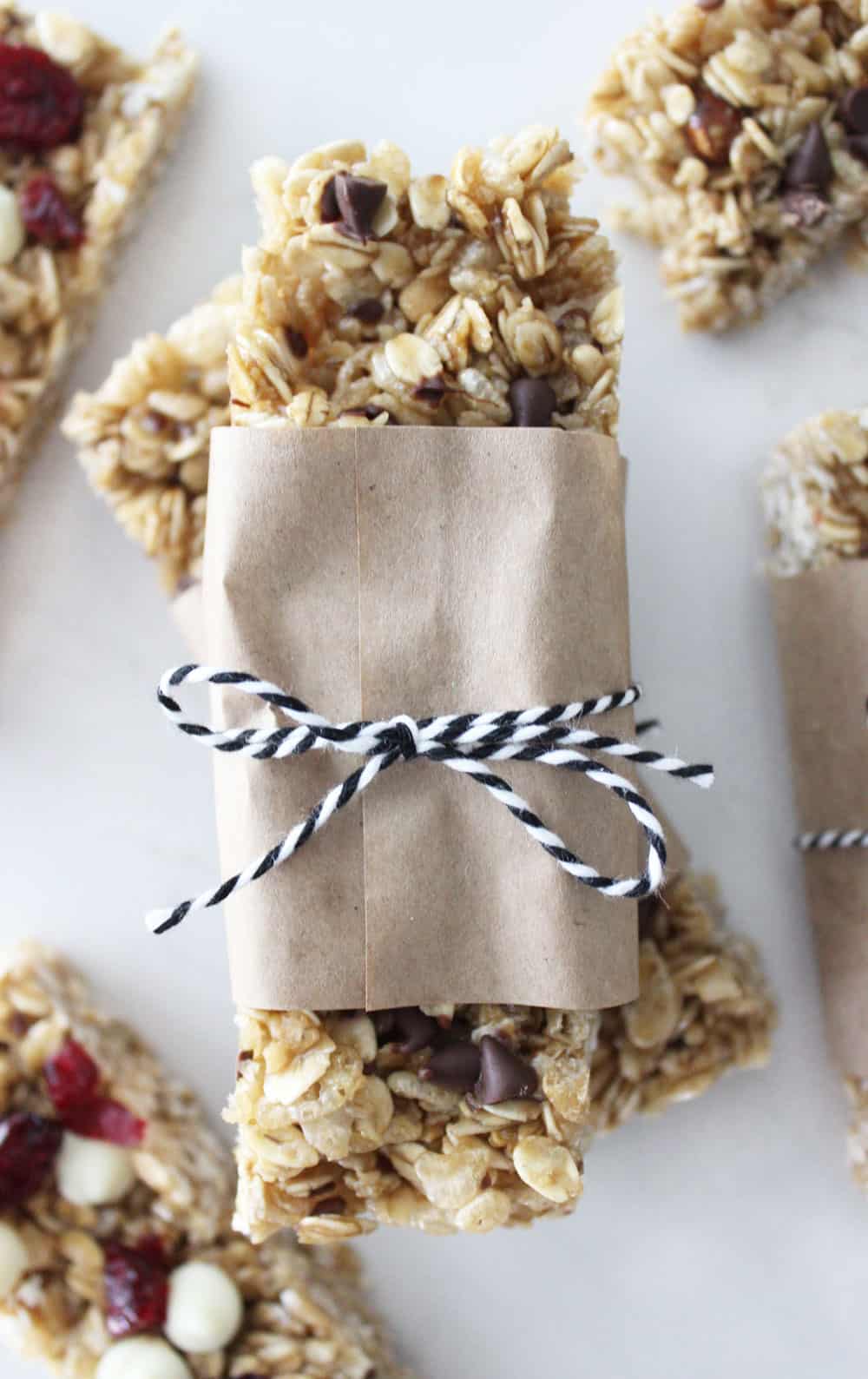 homemade granola bars stacked on each other wrapped in paper and twine