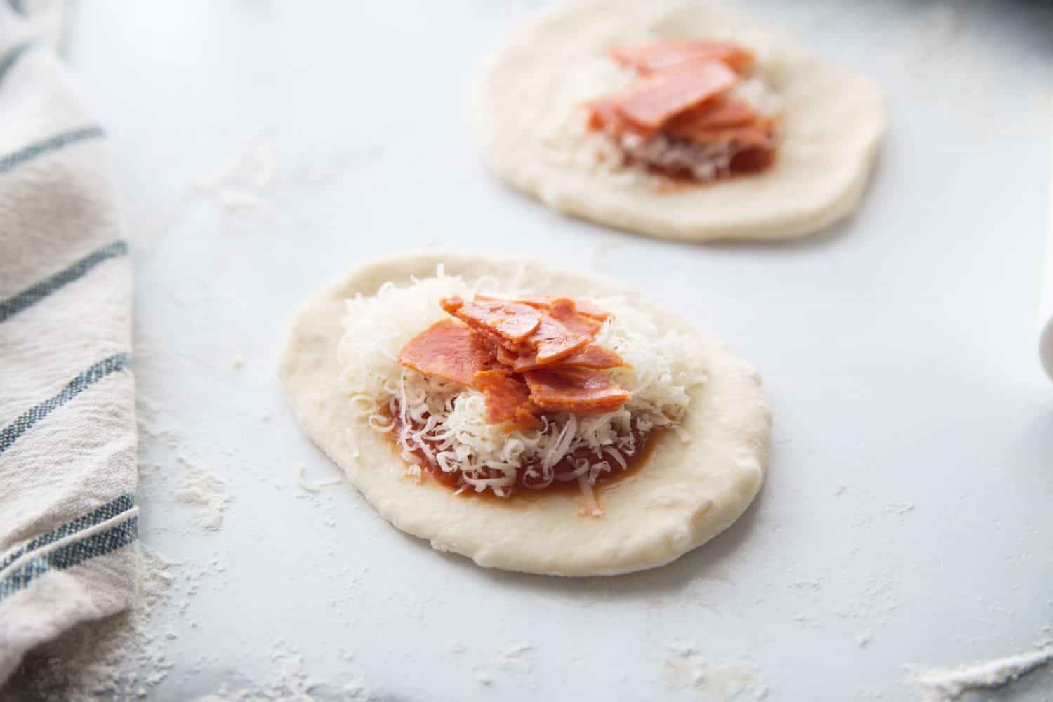 rolled out dough with pizza filling 