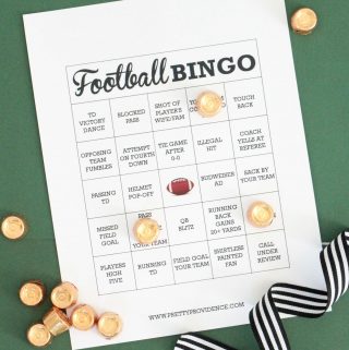 White football bingo card with black text, rolo candy as markers on a green background.