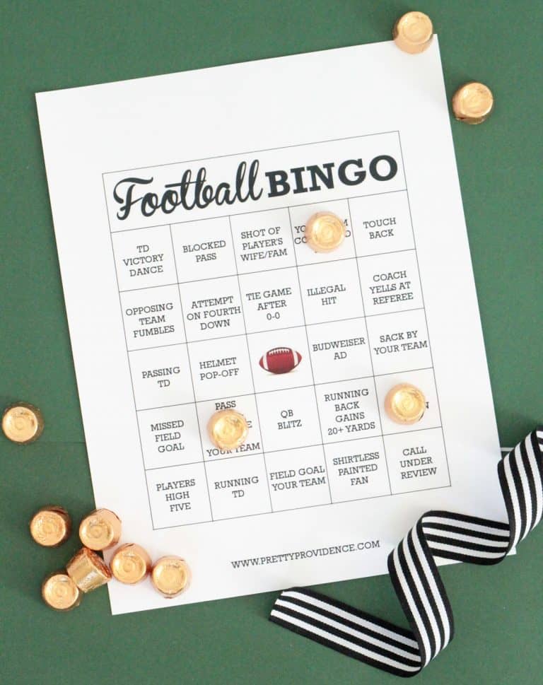 White football bingo card with black text, rolo candy as markers on a green background.