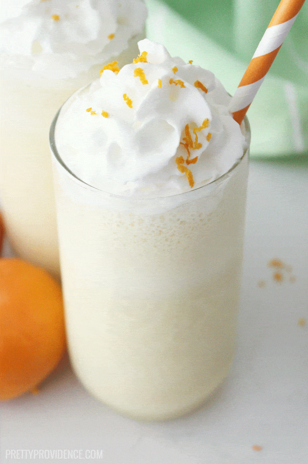 Orange julius copycat in a clear glass with sliced orange as a garnish. 