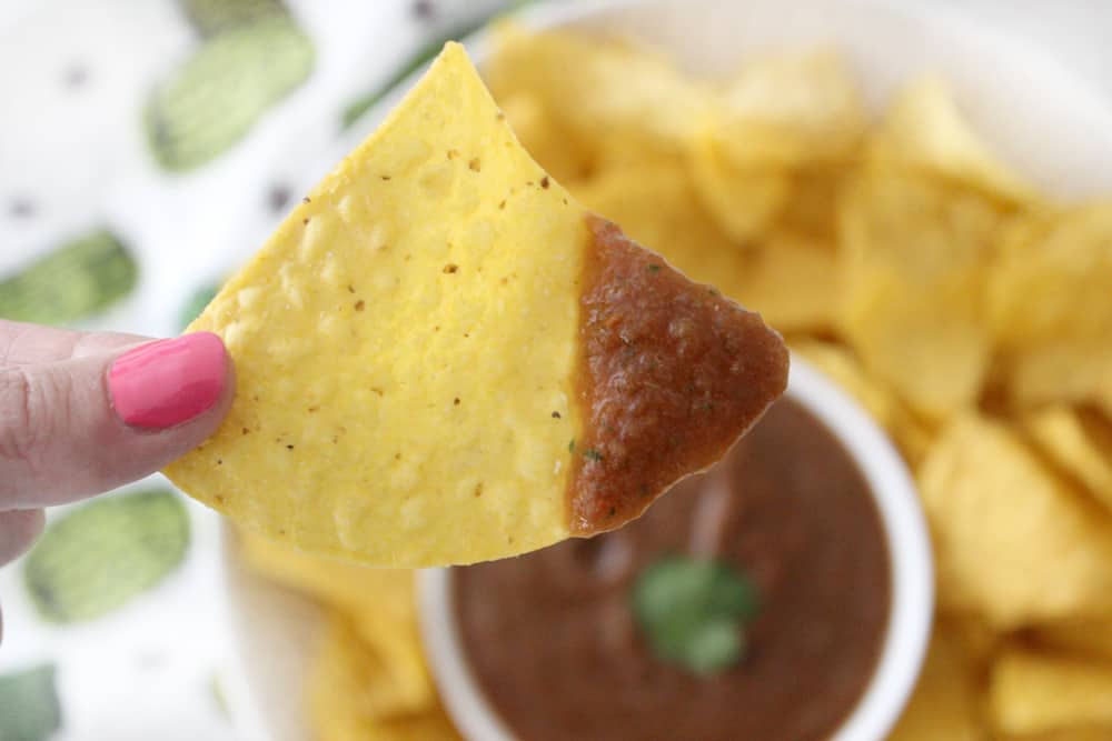 a chip dipped in blender salsa