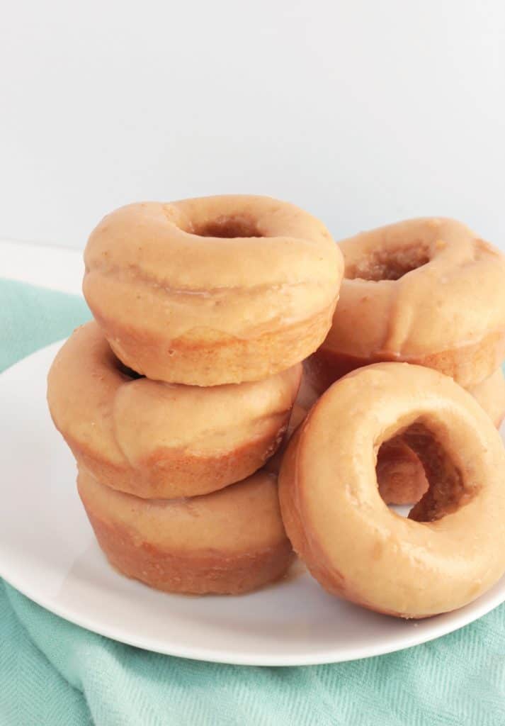 Stack of Cookie Butter Donuts on a white plate.