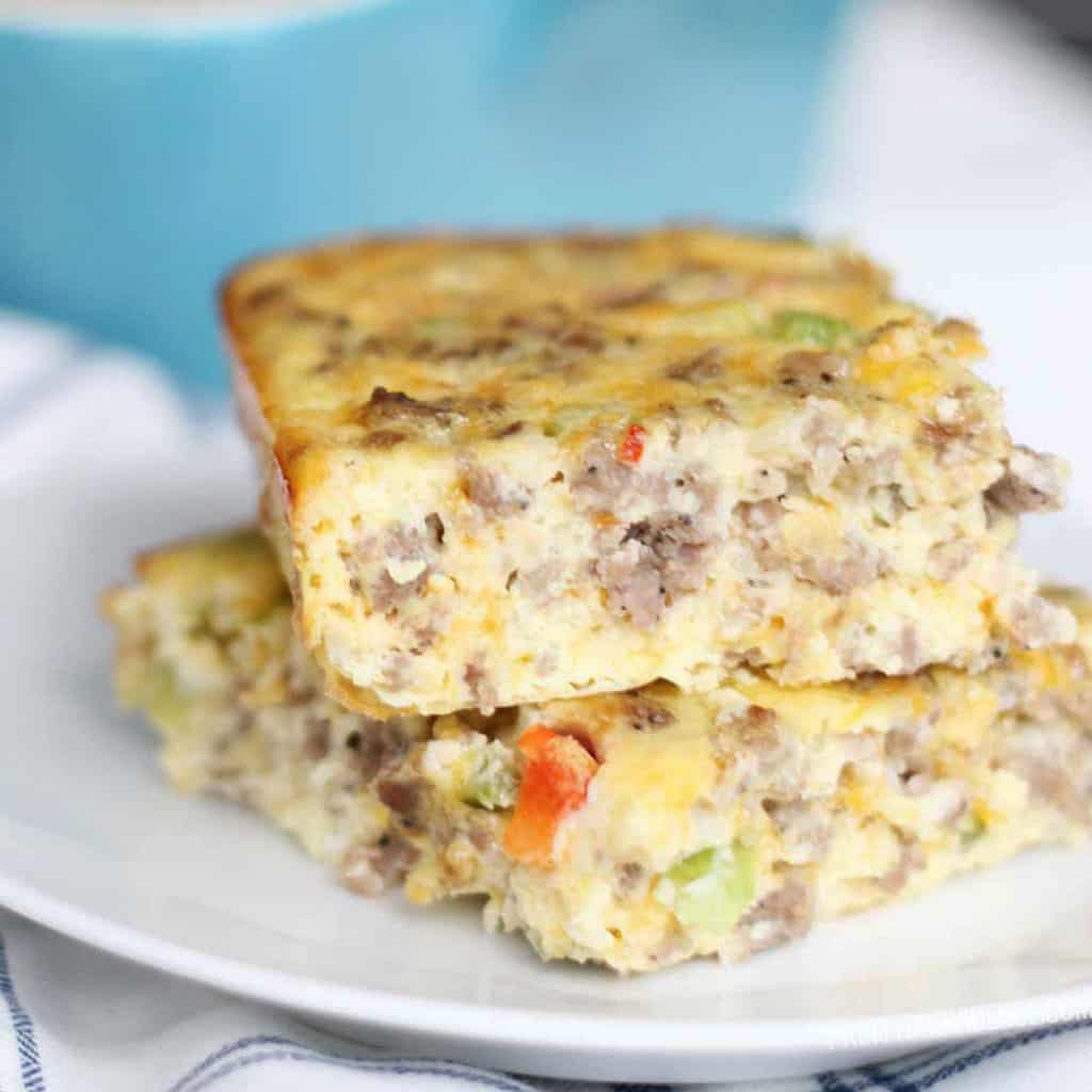 two slices of breakfast casserole stacked on a small white plate