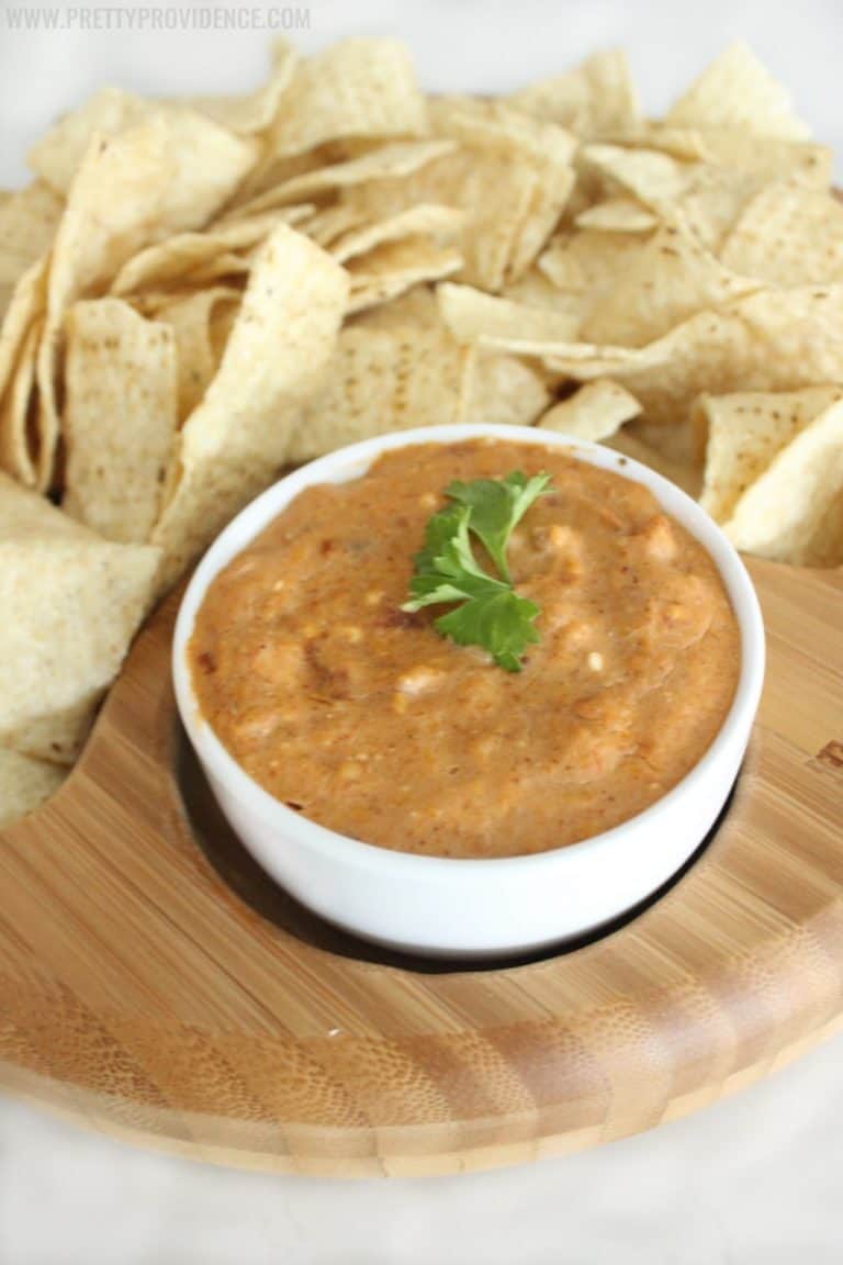 This cheesy crock pot bean dip is AMAZING!! Definitely my go-to recipe for any party or gathering-- a total crowd pleaser!