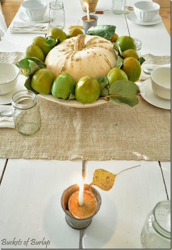 thanksgiving centerpiece: pumpkin and persimmons in a large bowl! simple and gorgeous