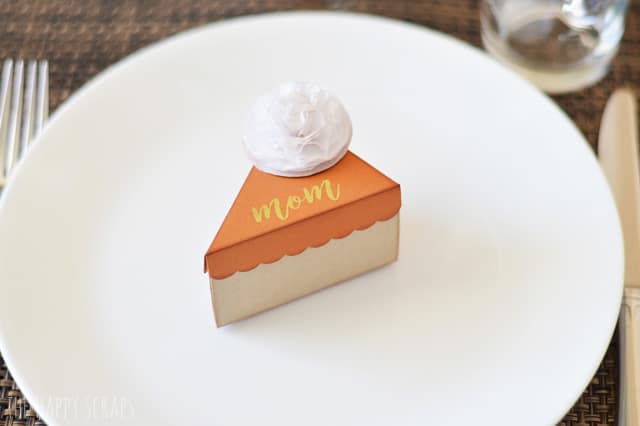 Mini Pie Box place card made out of card stock for Thanksgiving on a white plate.