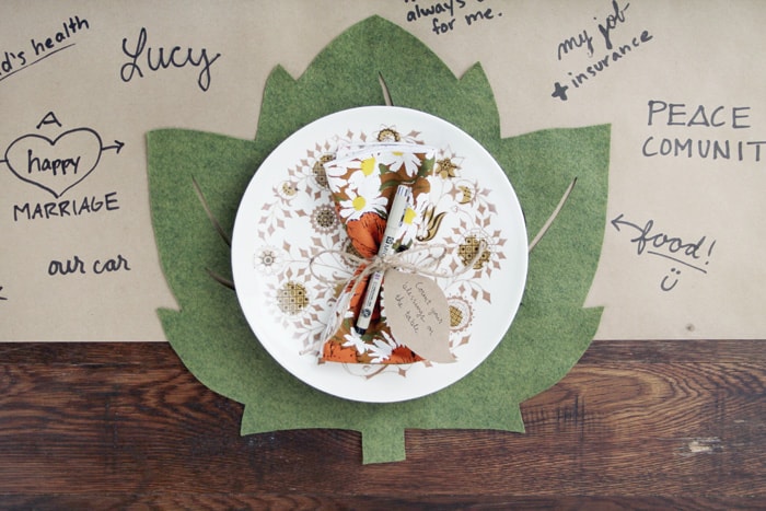 Green Felt Leaf Thanksgiving Place Mat on a kraft paper table cloth and under a plate.