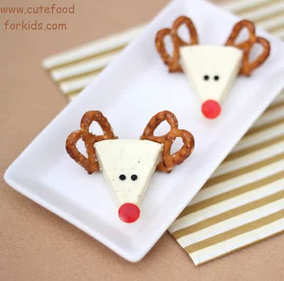 Reindeer Cheese snack with cheese wedge, pretzel antlers and red nose