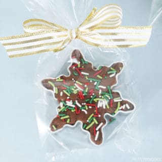 Homemade fudge in a star shaped cookie cutter, Christmas sprinkles on top, wrapped in a clear bag with gold ribbon