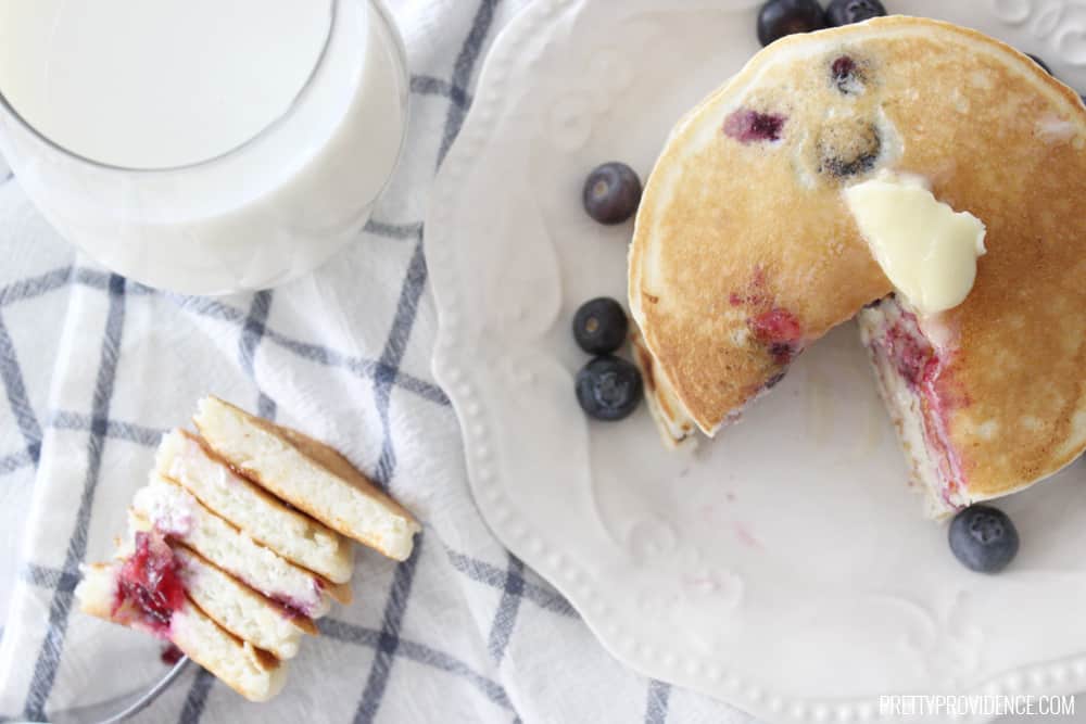 The BEST blueberry pancakes with blueberry syrup you will ever eat in your life! Seriously restaurant quality amazing.