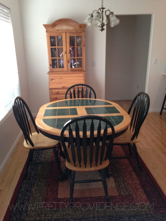 Oak and green tile tabletop, with matching dining chairs in a kitchen.