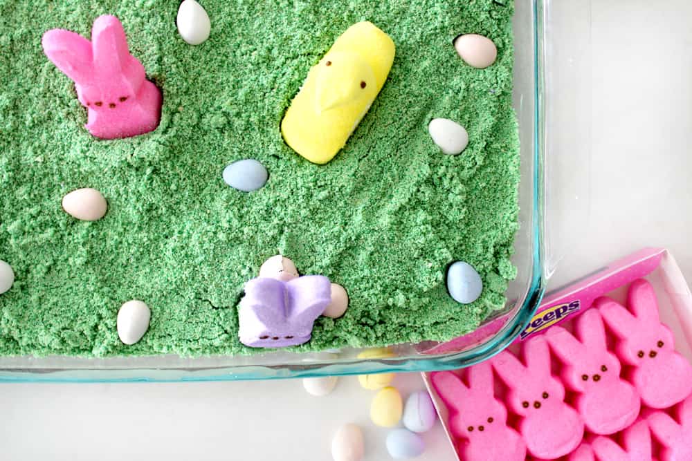 Easter dirt cake corner picture next to a box of pink Peeps. 