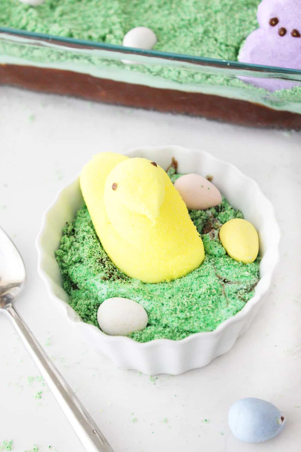 Easter egg dirt cake dished up in small white bowl. 