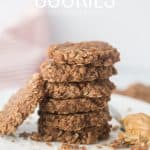no bake cookies stacked on a white plate with a towel in the background