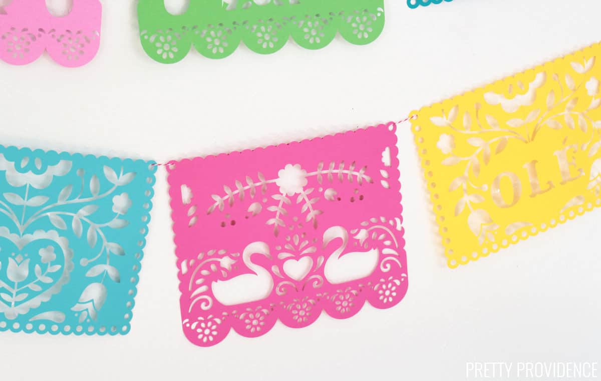 Papel Picado made from colorful card stock against a white wall