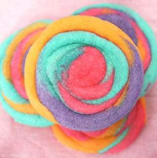 Tie-dye sugar cookie with neon pink, purple, turquoise and orange swirled together