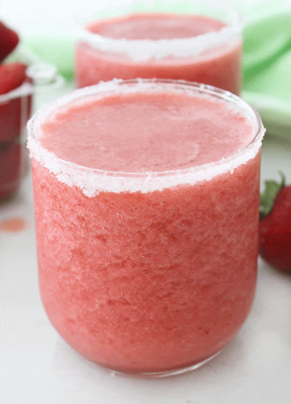 close up of a sugar rimmed glass of strawberry slush