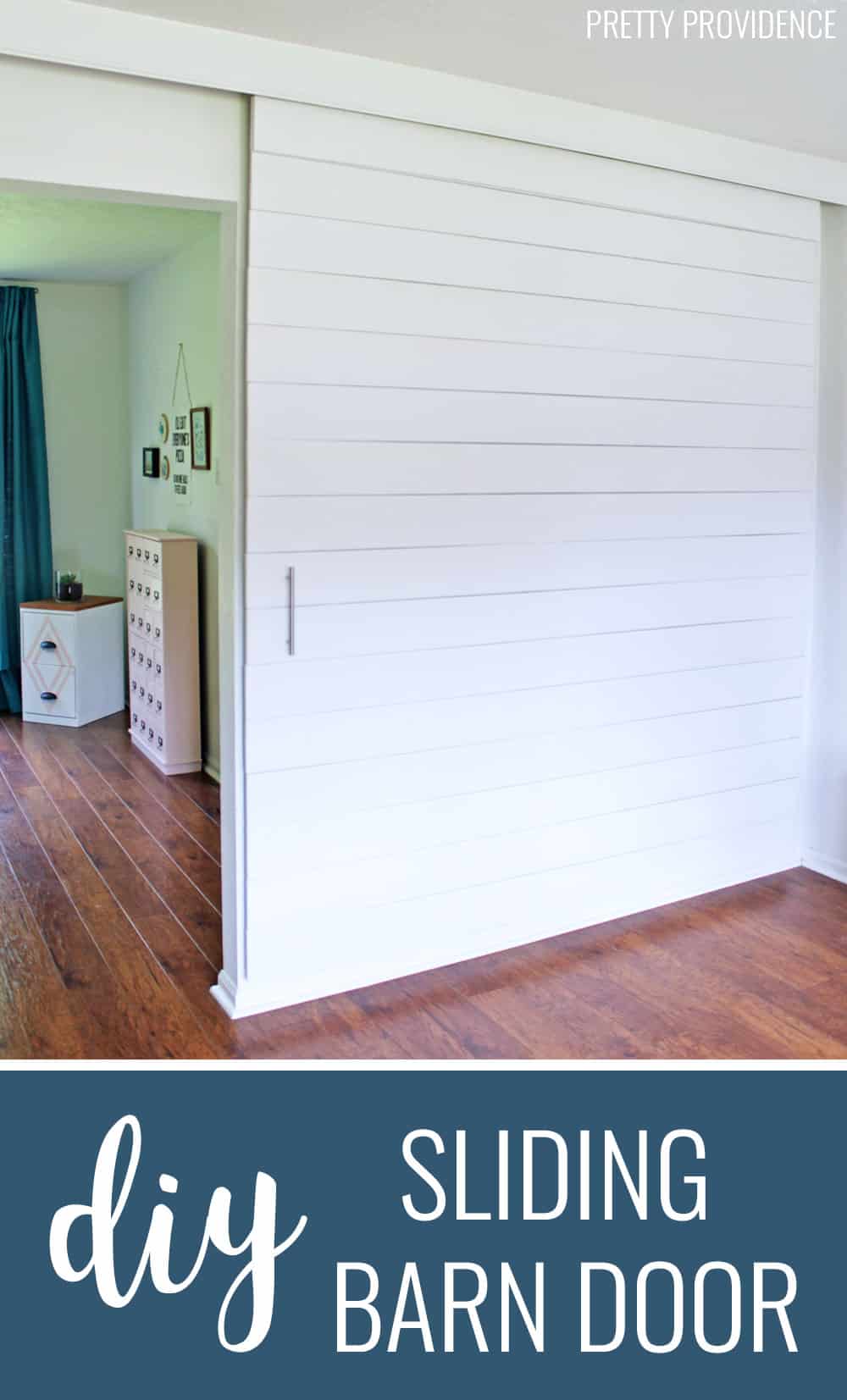 This DIY sliding barn door painted white is perfect DIY project for modern and farmhouse decor! 