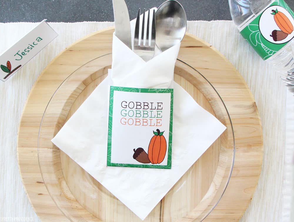 Free Thanksgiving Printable utensil holder, white card stock with a green border with words 'Gobble, Gobble, Gobble' on it.