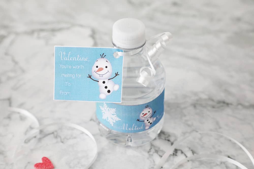 mini water bottle with valentines day printable wrapper on a granite countertop