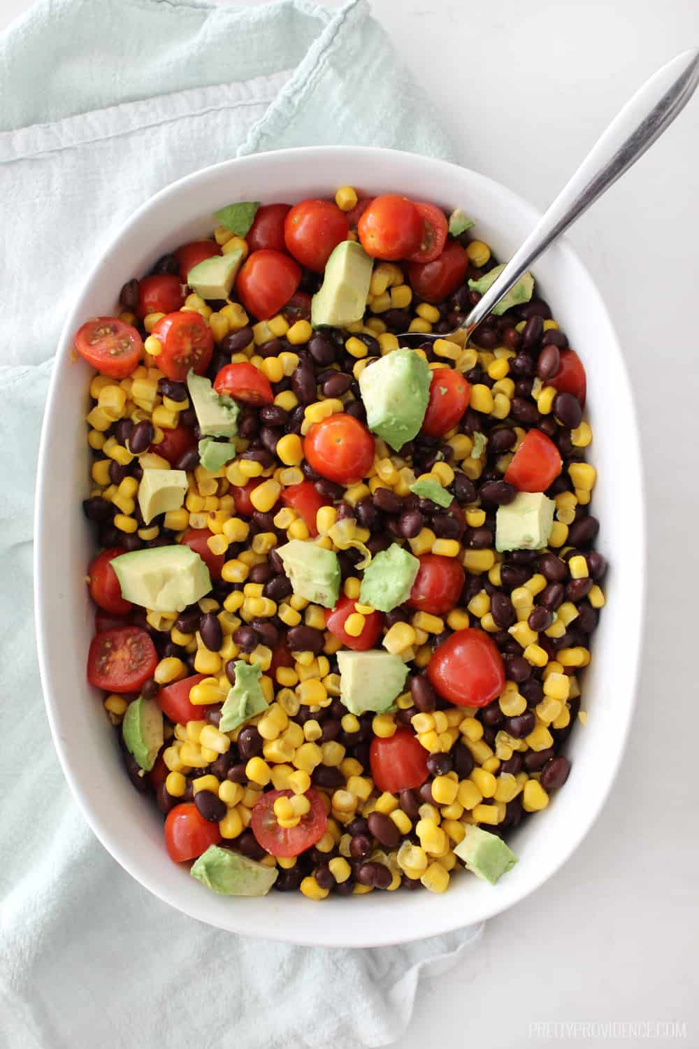 Corn, bean, tomato, avocado mixture for buffalo chicken bowls. 