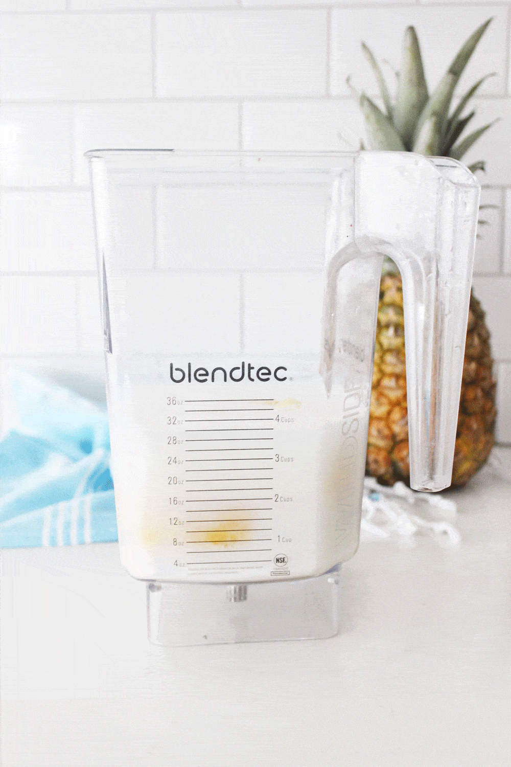 blendtec blender with coconut pineapple whip ingredients inside