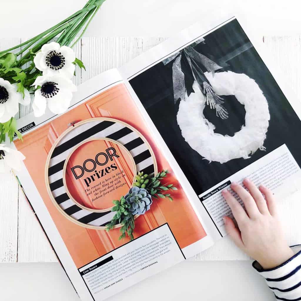 Black and White Striped Hoop Wreath in a Magazine next to a white Halloween wreath.