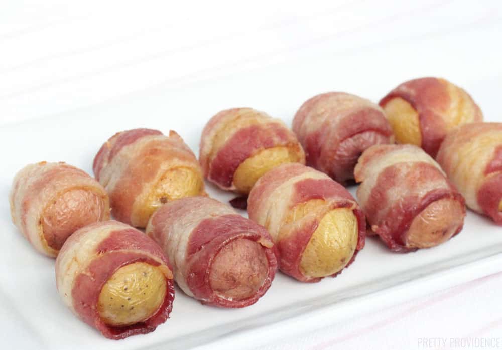 Bacon-Wrapped Potatoes on a white rectangle serving dish.