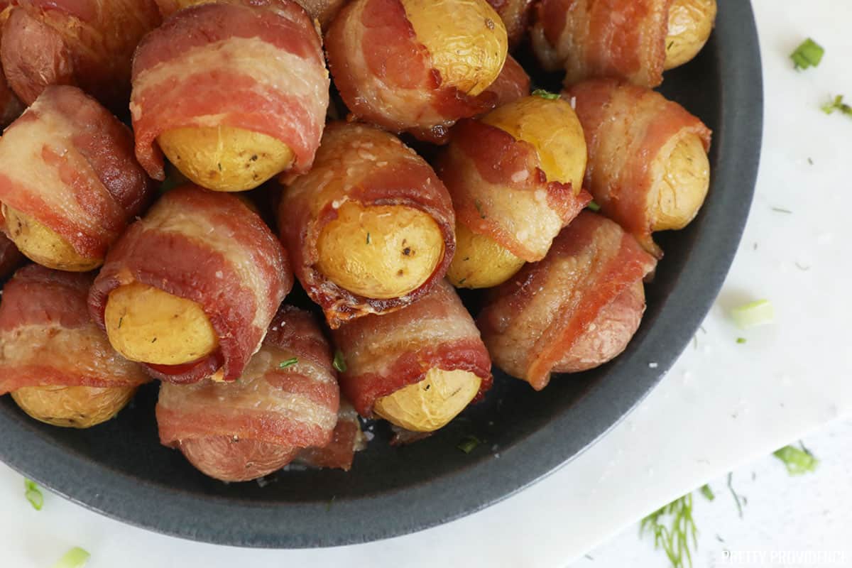 Bacon-Wrapped Potatoes on a white rectangle serving dish.