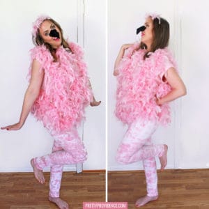 Woman wearing a DIY Flamingo costume, wearing pink and white tie-dye pants, pink feather boas and a black felt nose.