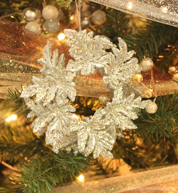 A close up of a christmas tree with gold and silver decorations