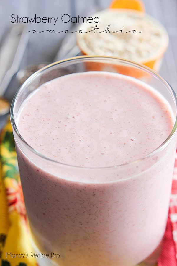 Strawbery Oatmeal Smoothie Strawberry Oatmeal Smoothie in a glass with oats in a measuring cup on top of a yellow floral dish towel.