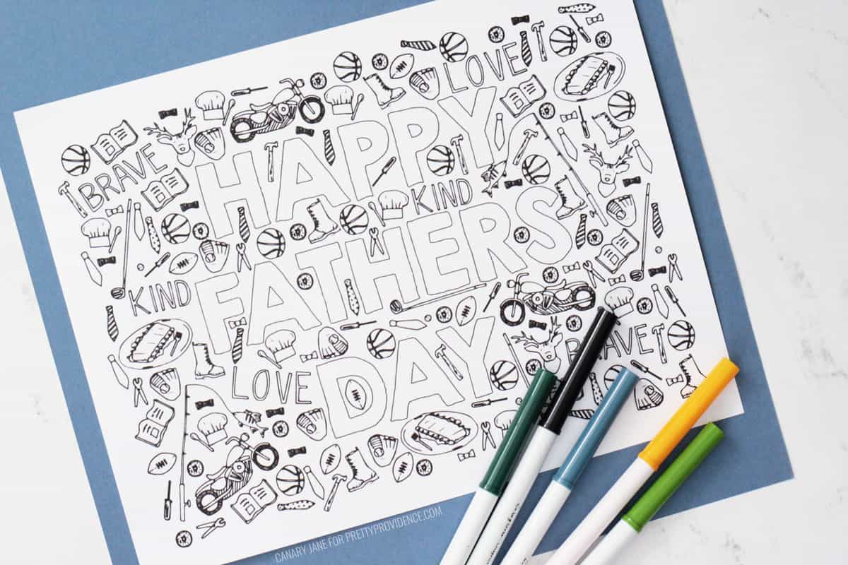 Father's day coloring page with hand-drawn details and markers below it.