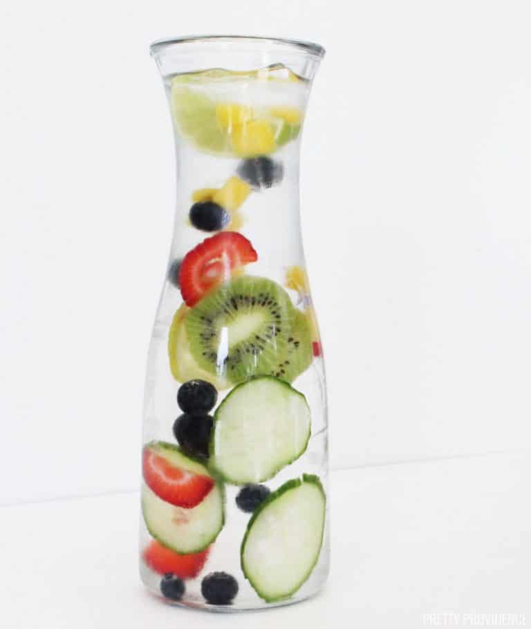 Strawberries, kiwi, cucumber, blueberries and mango in cold water, fruit infused water recipe.