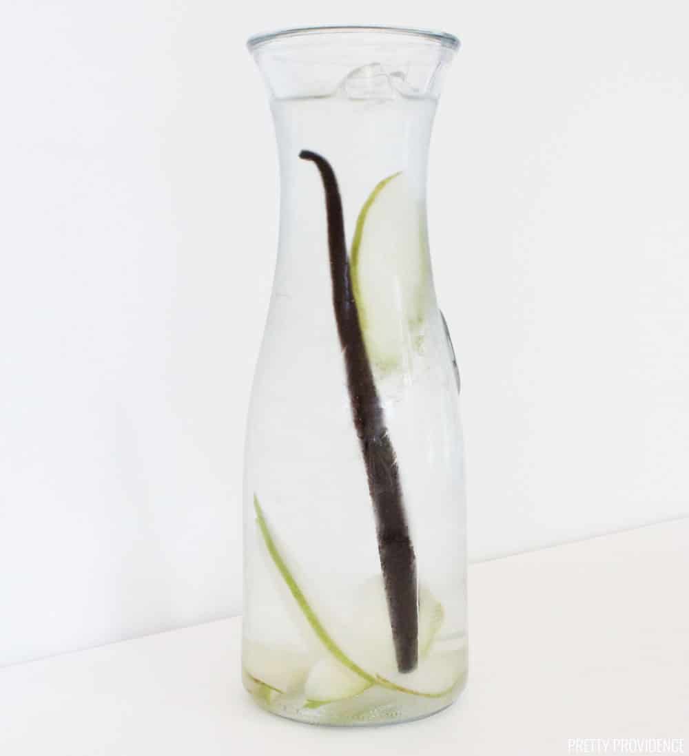 Vanilla bean and pear infused water in a glass bottle.