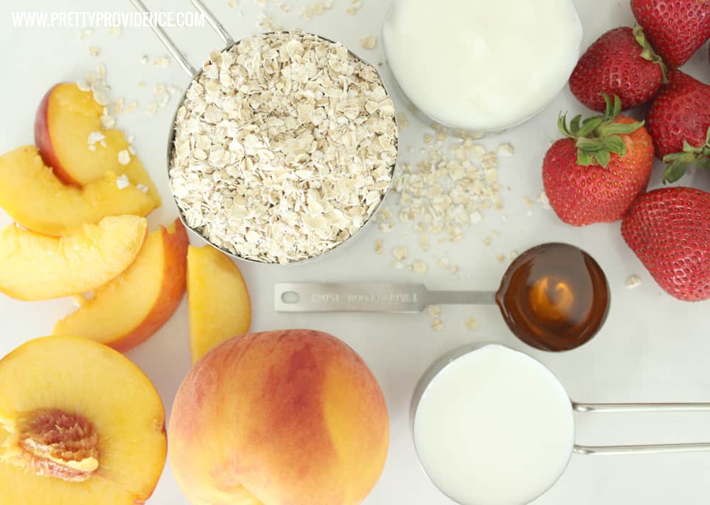 ingredients for a strawberry peach smoothie artfully arrayed on a granite countertop