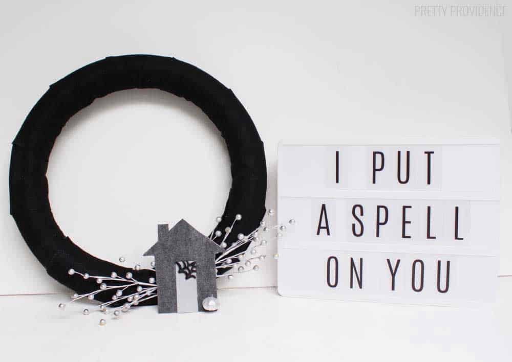 Haunted House wreath made with black felt and gray felt, with a lightbox next to it that says 'I put a spell on you'