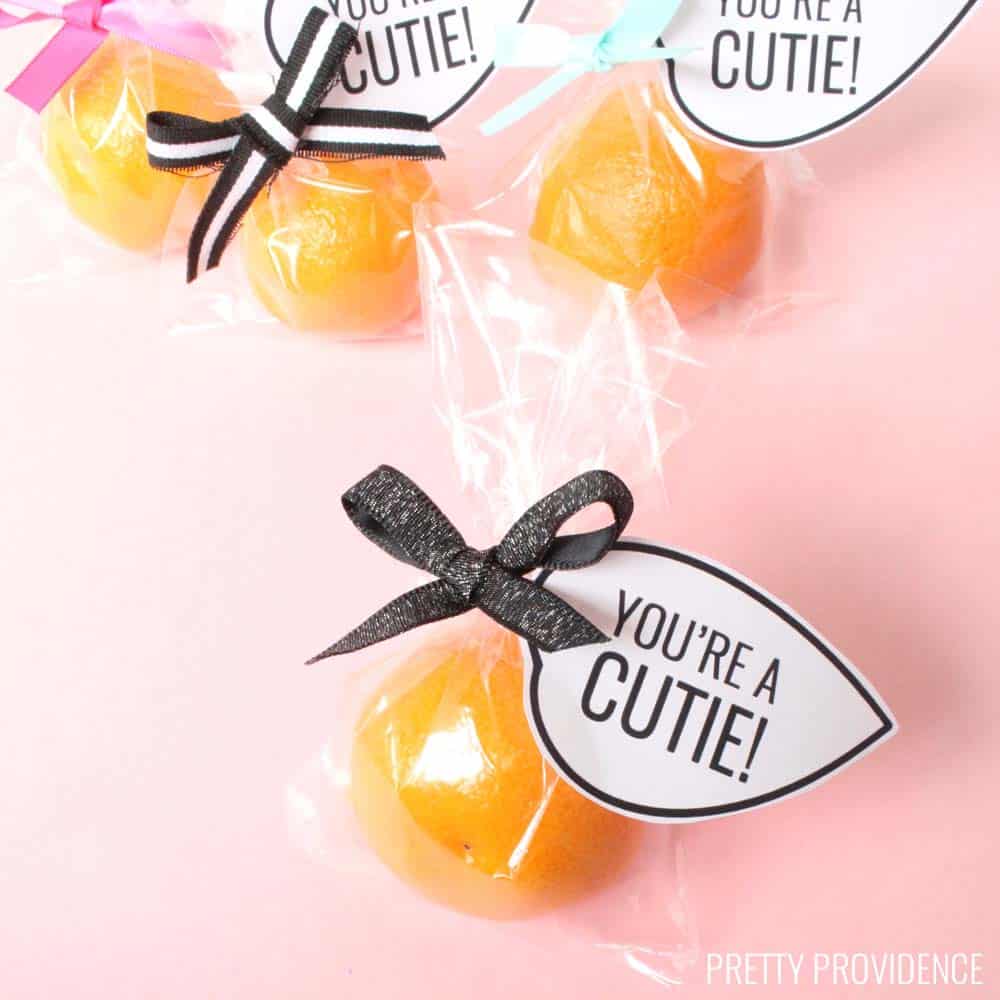 You're a Cutie Valentine printable leaf tag tied onto a small mandarin orange in a clear bag.