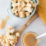 homemade caramel next to a bowl and a spoon filled with caramel popcorn
