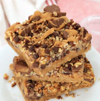 These peanut butter magic bars are to die for! Like magic cookie bars but with Reeses minis + melted peanut butter!