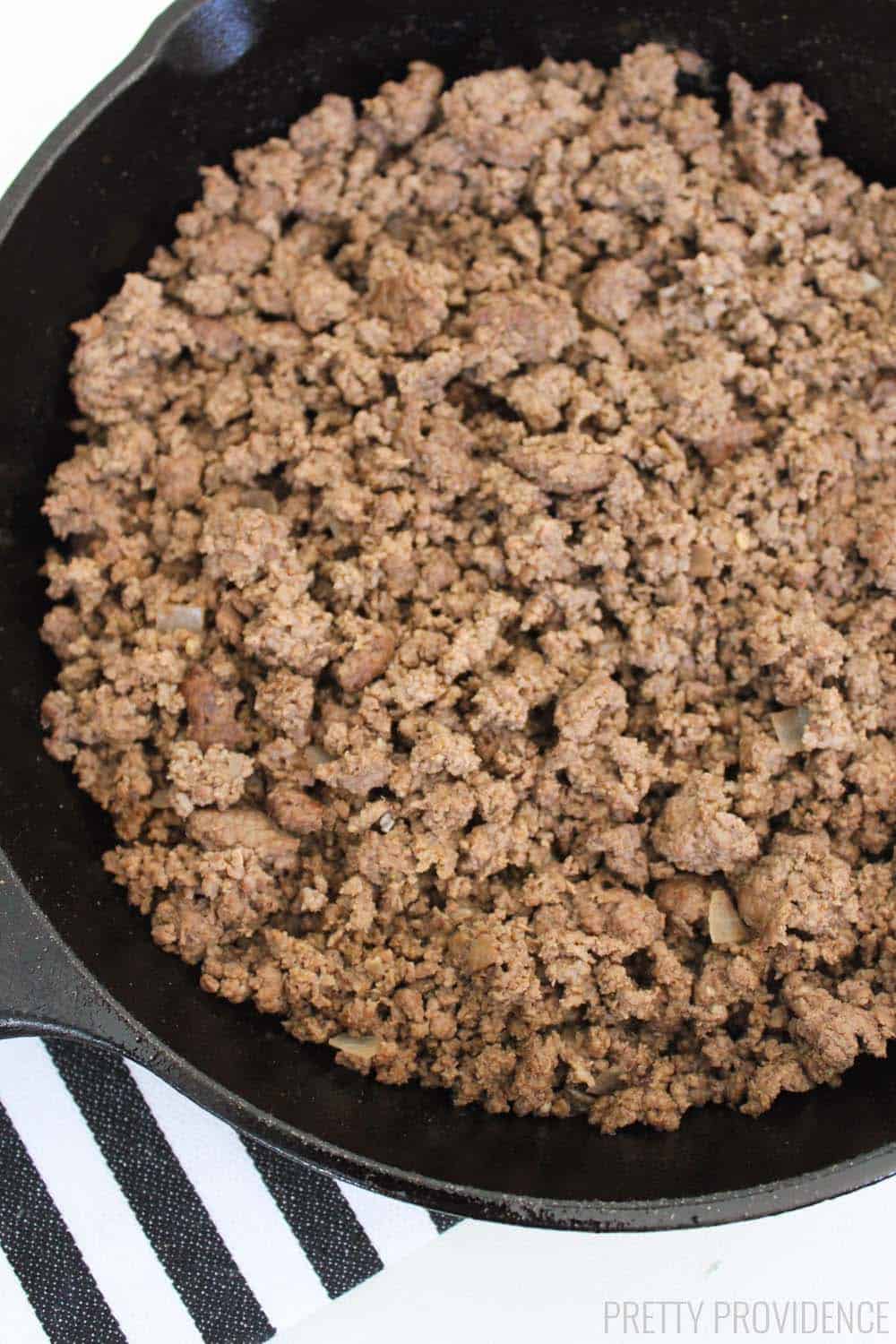 close up image of cooked ground beef in a cast iron pan