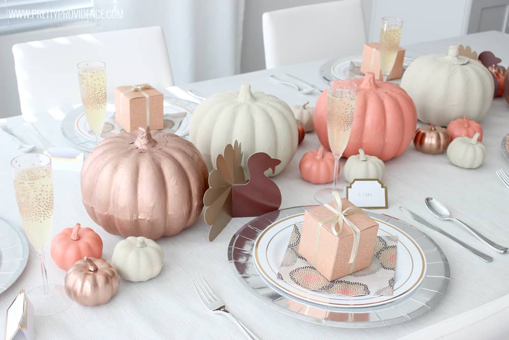 Thanksgiving Table Decorated with pumpkins in orange, cream, bronze and brown color scheme.