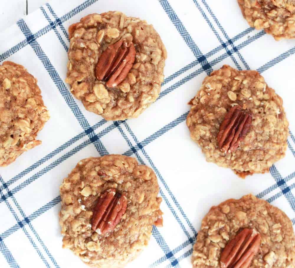 Maple Pecan Oatmeal Cookies with pecans in the middle of each one.