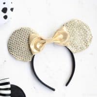 gold diy disney ears with a gold bow on a white background