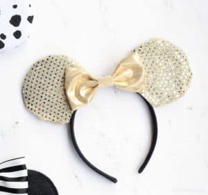 gold diy disney ears with a gold bow on a white background