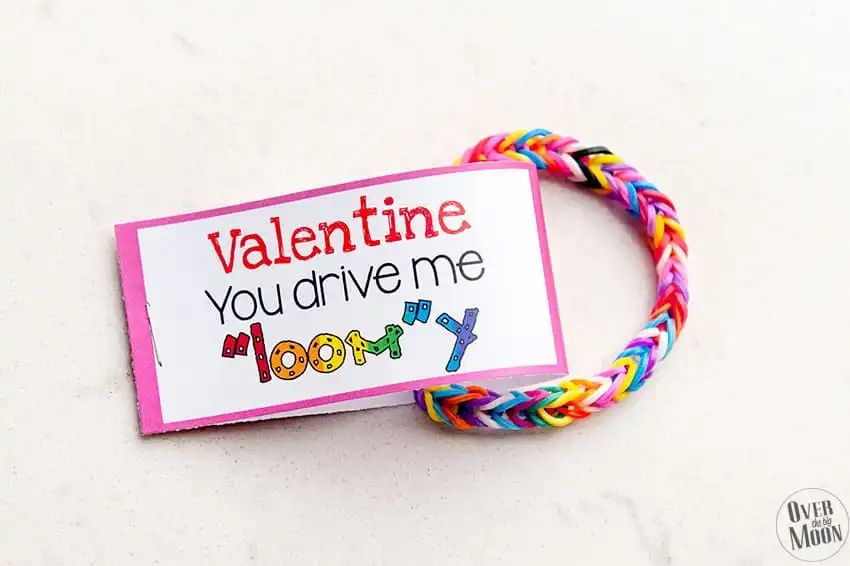 Rainbow Loom bracelet with a Valentine on it that says 'Valentine, you drive me Loomy"