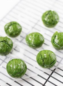 Healthy Green Muffins mini sized on a cooling rack and glazed. 