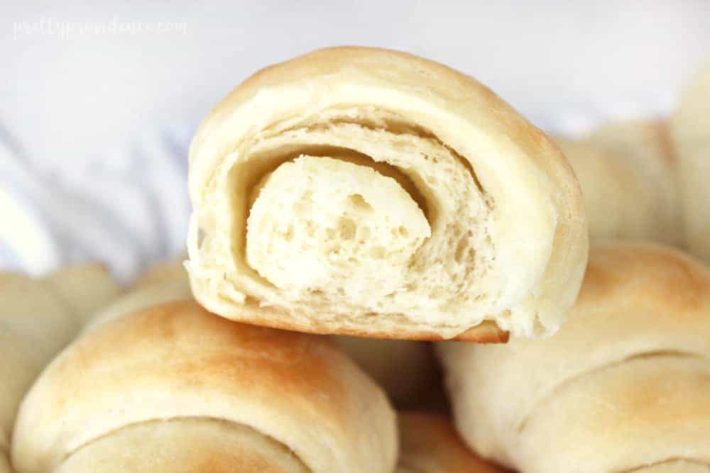 homemade yeast rolls ripped open so you can see the airy middle