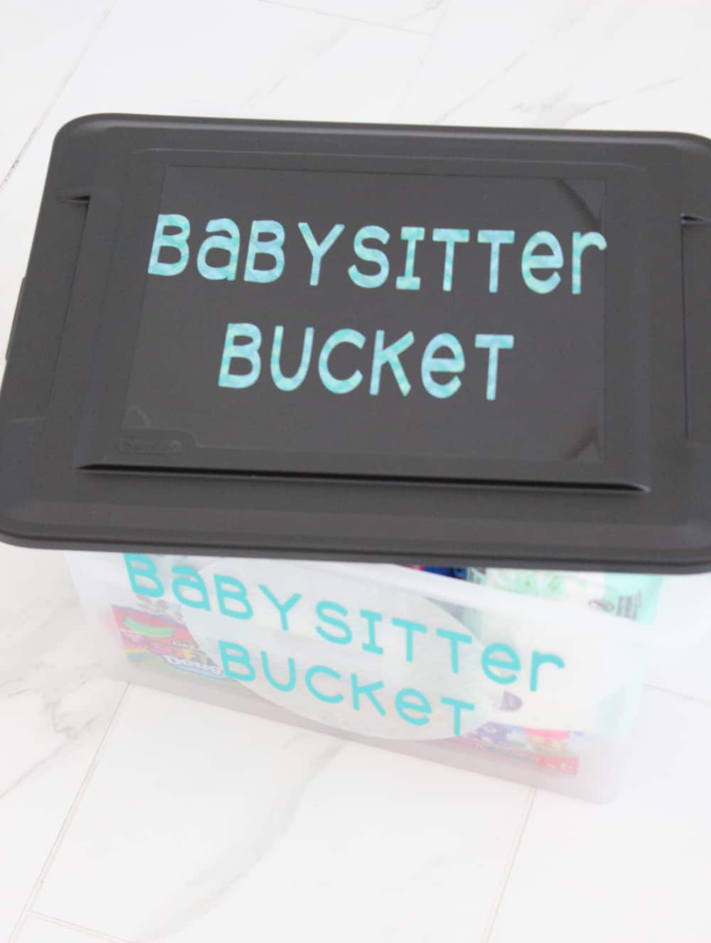 Babysitter bucket filled with all the essentials a baby sitter will need to care for your kids, plus fun toys and games! 